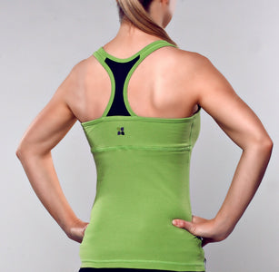 Model wearing apple green color racer back tank top with black contrast fabric at center back