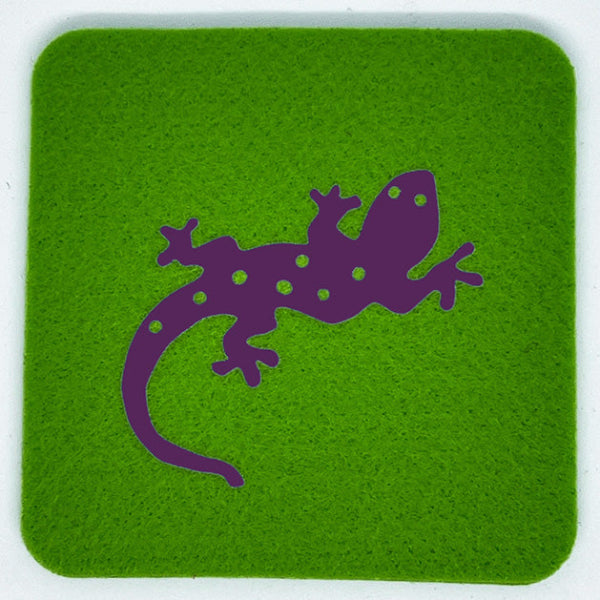 Closeup product image of a bright apple green square wool coaster with a purple gecko design centered on it