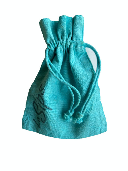 Closeup front view of a turquoise aqua colored hand dyed drawstring travel bag with the word LeSips stamp printed along the side