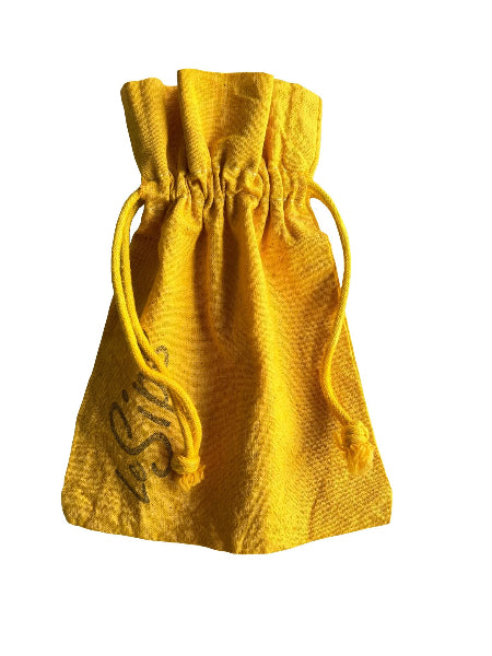 Closeup front view of a yellow colored hand dyed drawstring travel bag with the word LeSips stamp printed along the side