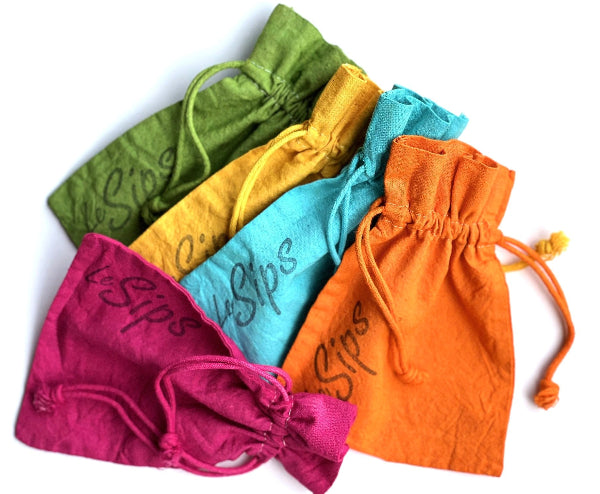 Top view product image of colorful hand dyed drawstring travel bags with the word LeSips stamped vertically on them