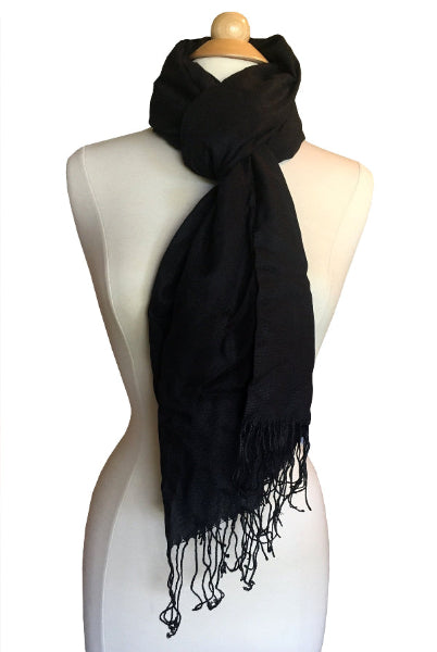 Product image of black pashmina shawl scarf wrapped around the neck of a designer model form