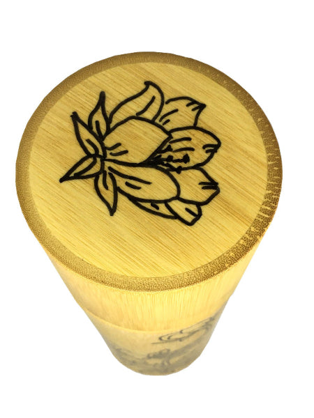 Closeup of top of a bamboo container with floral decoration hand drawn on top