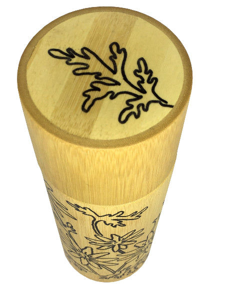 Closeup image of top lid of a bamboo container with hand drawn leaf design