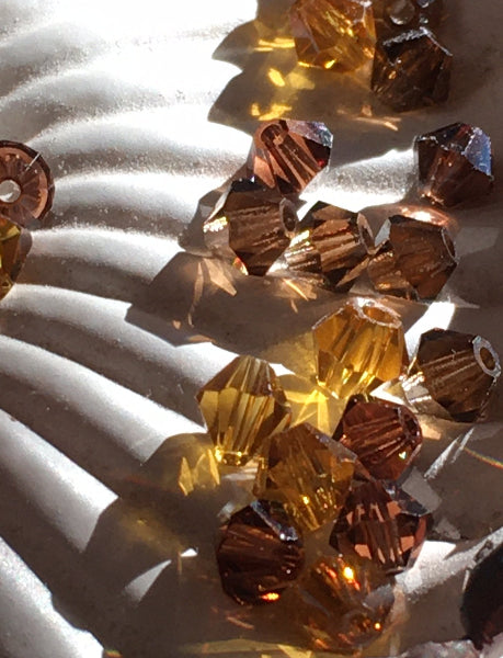 Closeup of swarovski crystal beads in a shell shaped dish