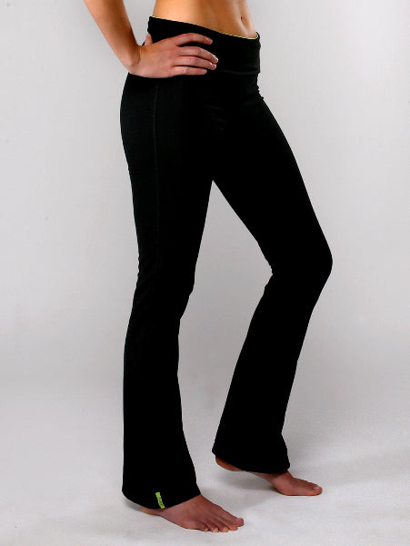 Product image of a model's hips and legs wearing black boot cut yoga pants with a flared leg opening and bare feet