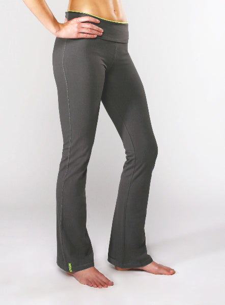 Closeup product image of a woman from the waist down, wearing a pair of grey boot cut fit yoga pants with fold over waistband