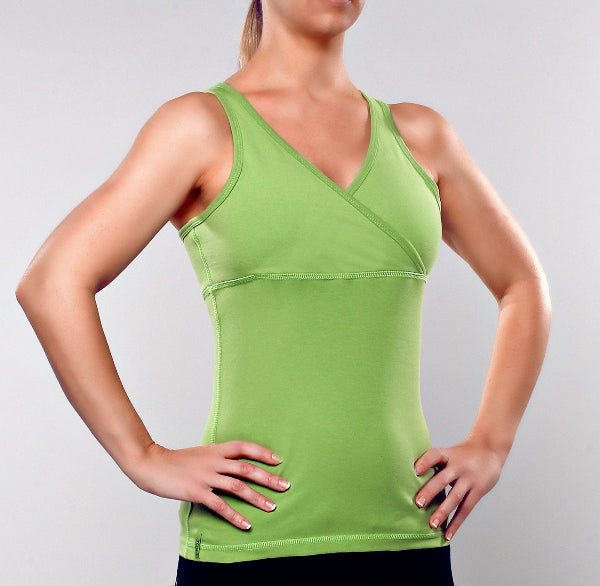 Woman wearing apple green color tank top and black leggings