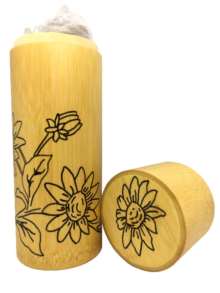 Closeup product image of a bamboo container with a grey pashmina scarf inside of it and hand drawn black flower design on the outside of the bamboo container and lid