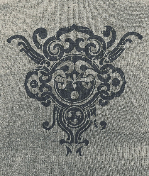 Closeup image of grey heather t-shirt fabric with a dark grey henna like printed interlocking graphic design