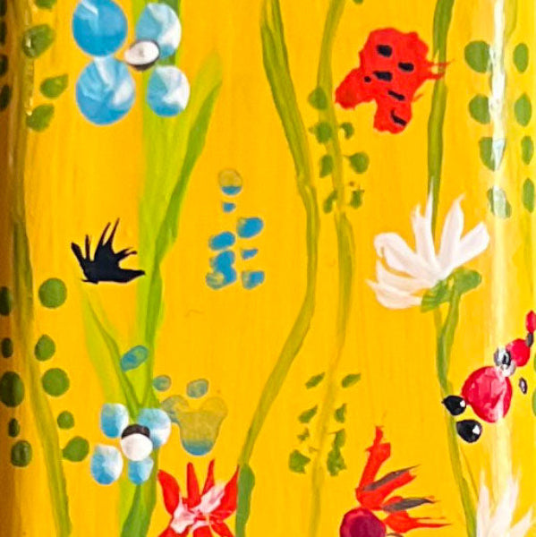 Closeup front view image of hand painted yellow with small flowers 