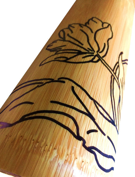 Closeup view image of a bamboo container with hand drawn black line art of a tulip 