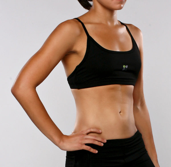 Image of female athlete wearing a black sport bra and black running shorts