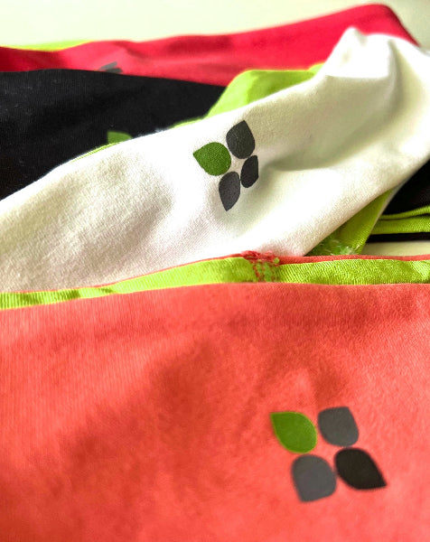 Closeup product image of four wide headbands with Yoga City logo printed on them