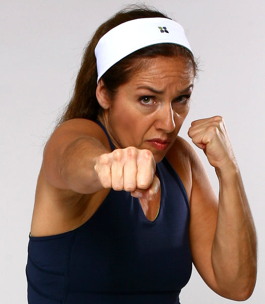 Image of a martial arts instructor wearing a blue yoga tank top and a white wide headband with a Yoga City logo printed on the front