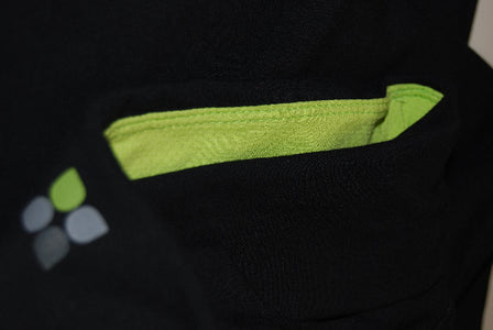 Closeup product image of a black fold over waistband with apple green accent mesh inside of the waistband